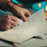 Man signing a document with a pen